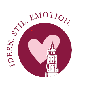 Signet: Daniel-Turm im Herzen, umrundet vom Claim „Ideen. Stil. Emotion.“
